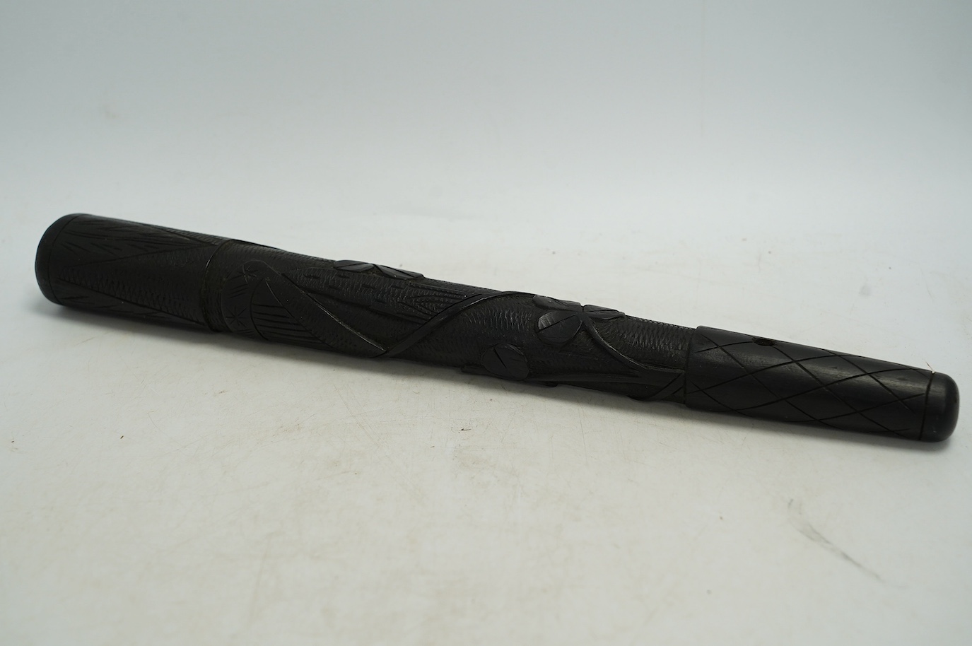 A late 19th/early 20th century Irish bog oak truncheon, carved with a harp and clovers, 37cm in length. Condition - good